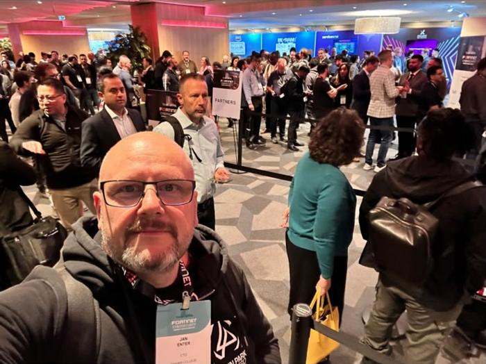 A selfie in front of a packed exhibit floor.