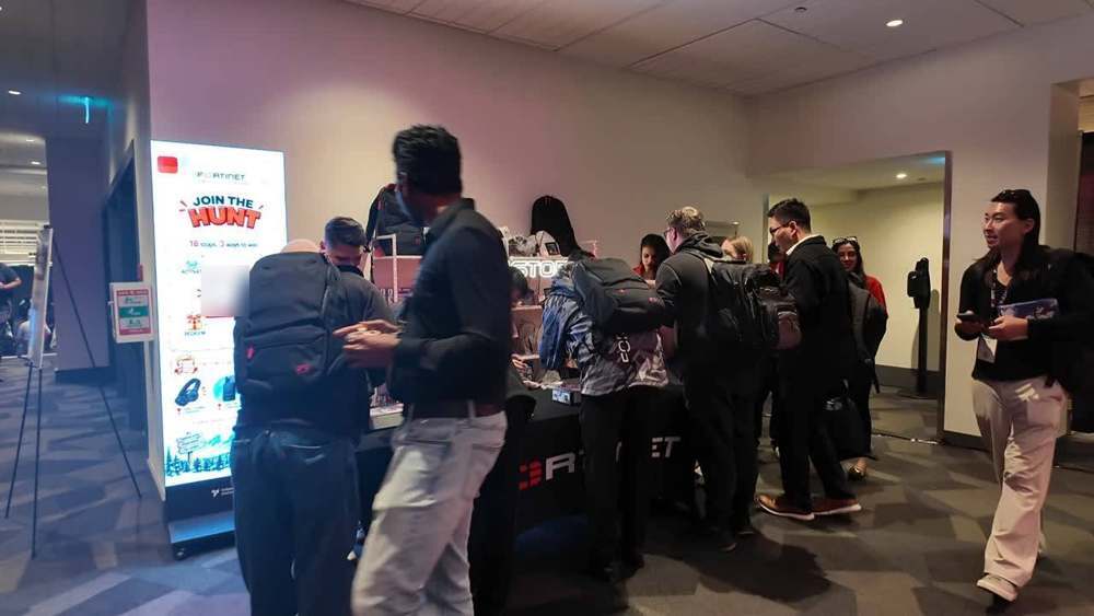 Attendees crowding the prize store table to redeem tokens.